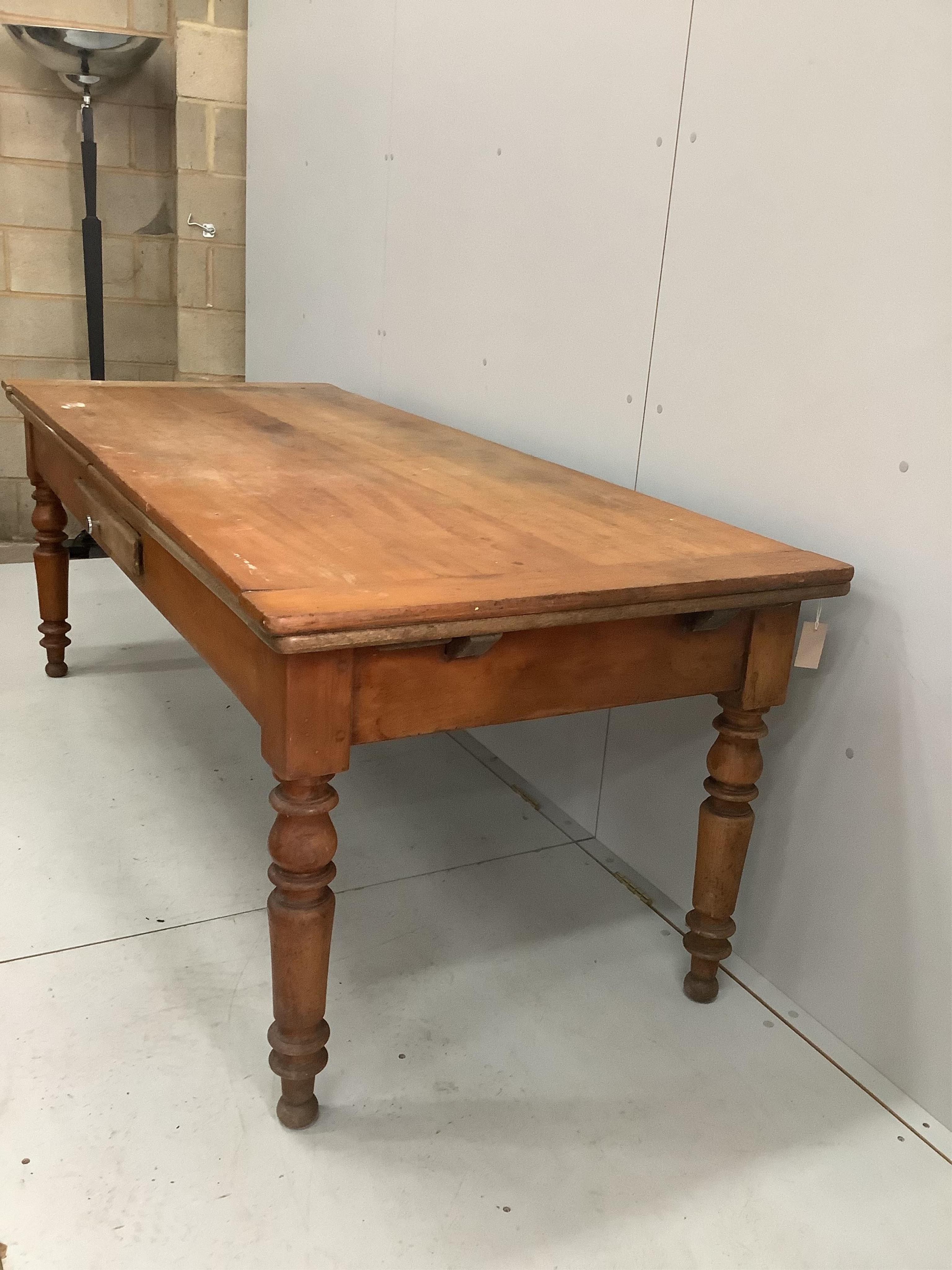 A 19th century French draw leaf kitchen table, width 200cm, depth 84cm, height 76cm. Condition - fair